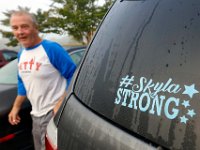 Murdoch Lynk walks past the sticker on the back of his van.  Skyla Lynk-Romano, 15, who suffered a traumatic brain injury when she was struck by a car on January 5th attends her first day of school at the Greater New Bedford Regional Vocational Technical High School after a long rehabilitation process at the Pappas Rehabilitation Hospital for Children in Canton, MA. On January 5, 2017, Skyla, a freshman at Greater New Bedford Regional Vocational-Technical High School, was crossing Dartmouth Street to meet her father after leaving the Dancer’s Edge studio when she was hit by a car and critically injured. The driver, Jessica Skaggs, 34, fled the scene before turning herself in. Skaggs has been sentenced to six months at the House of Corrections, but the sentense was suspended for two years. PHOTO PETER PEREIRA